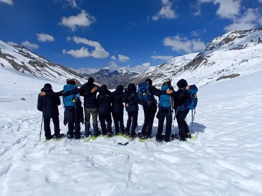 group of youth in snow-covered mountain landscape